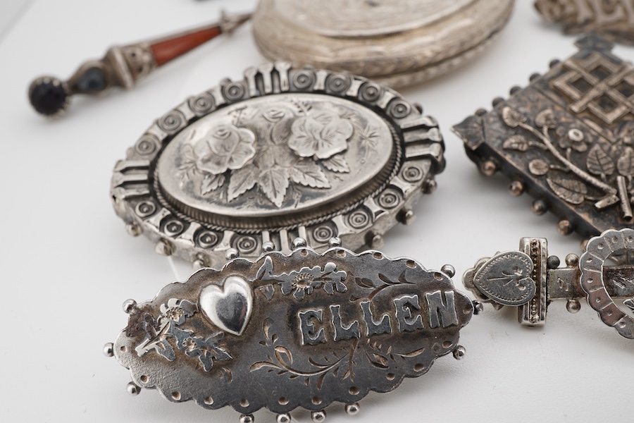 Ten assorted late 19th/early 20th century silver brooches, including three with names, Baby, Millicent and Ellen, together with five other white metal brooches including Scottish hardstones, a coin set stick pin, hardsto
